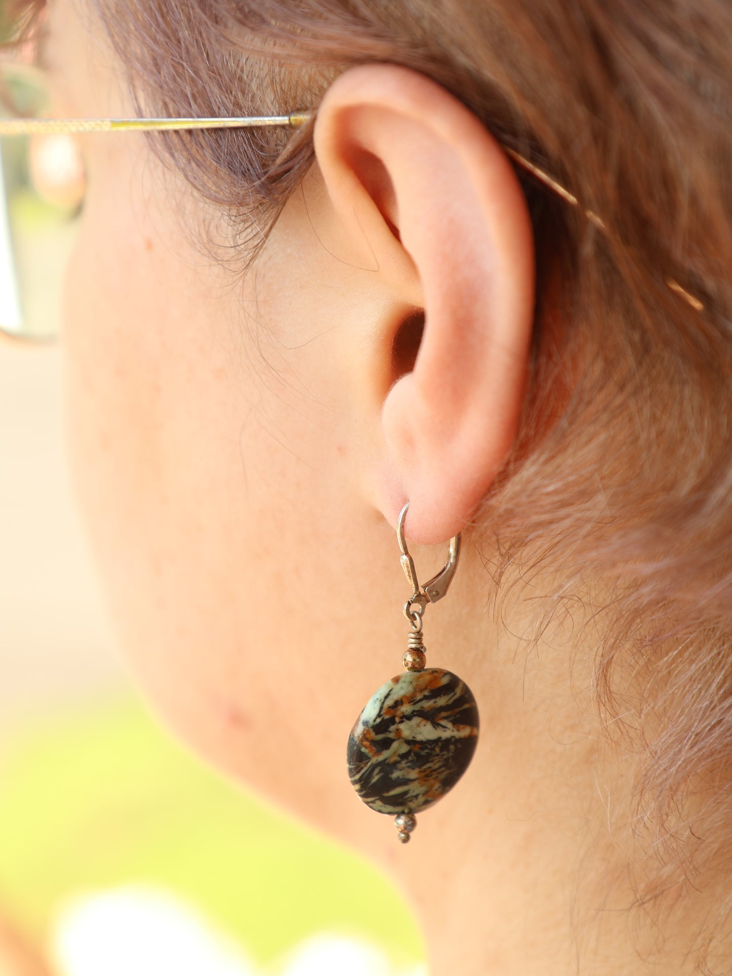 Close-up of an ear with a decorative earring.